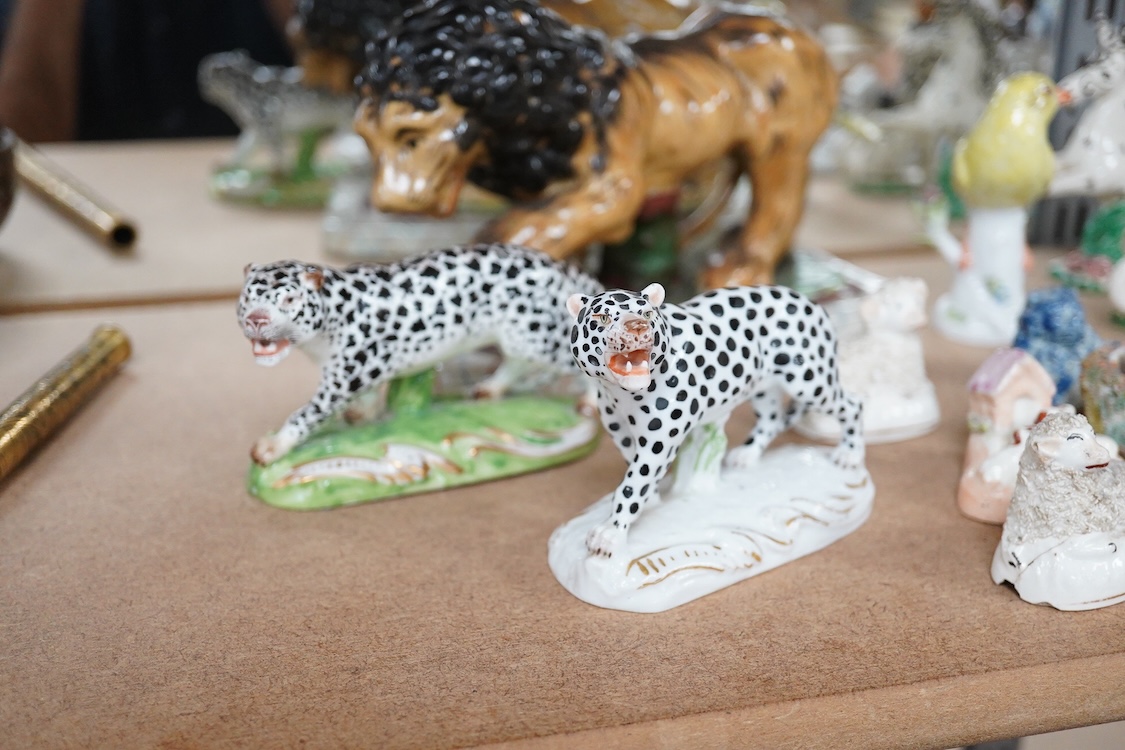 A collection of 19th/20th century Staffordshire and continental porcelain models of animals and birds, including a 20th century Meissen figure of a canary, two Continental porcelain Panthers, two similar recumbent dogs,